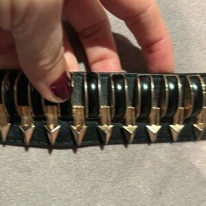 Black stretchy belt with heavy gold accents .. statement belt